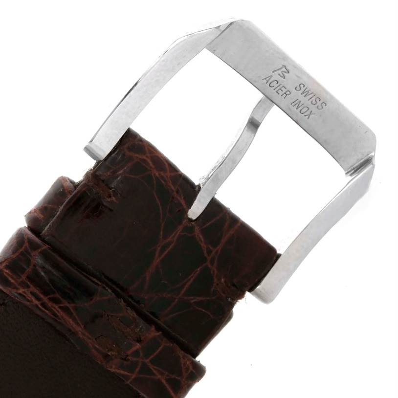 This image shows a close-up of the stainless-steel buckle and brown leather strap of an IWC Pilot IW325110 Men's Stainless Steel Silver Dial IW325110 Men's Stainless Steel Silver Dial model watch.