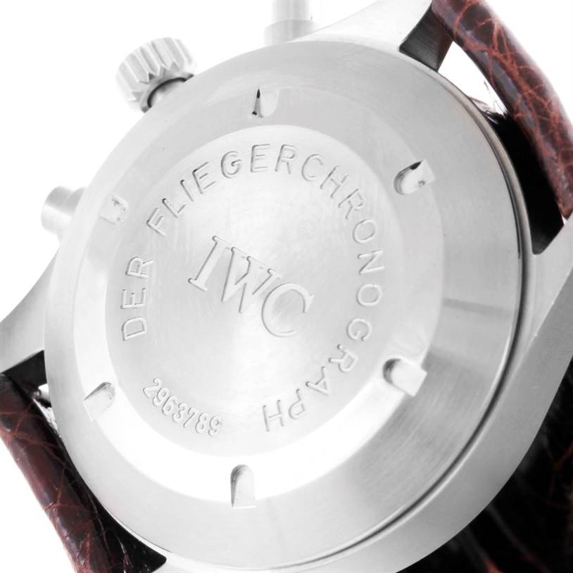 The image shows the case back of an IWC Pilot IW325110 Men's Stainless Steel Silver Dial IW325110 Men's Stainless Steel Silver Dial model watch, highlighting the engraved text and the serial number.