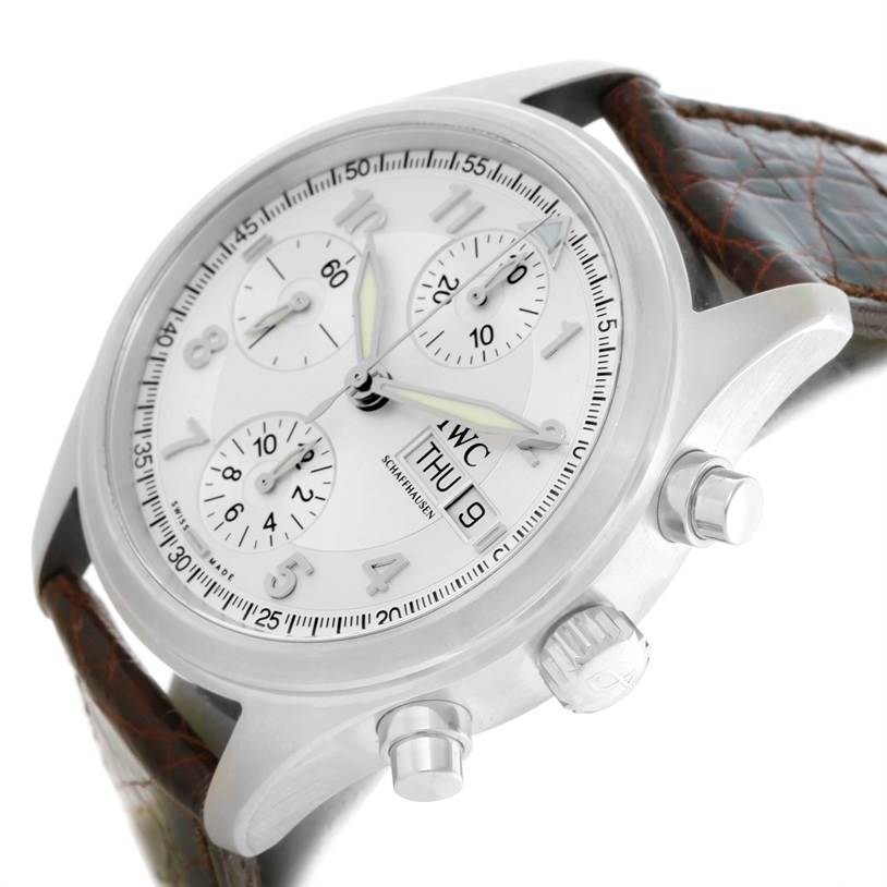 This image shows a close-up of the IWC Pilot IW325110 Men's Stainless Steel Silver Dial IW325110 Men's Stainless Steel Silver Dial watch from an angled side view, highlighting the dial, subdials, pushers, and leather strap.