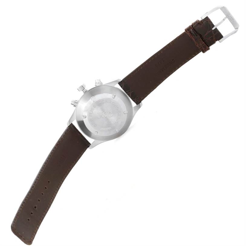 The image shows the back of an IWC Pilot IW325110 Men's Stainless Steel Silver Dial IW325110 Men's Stainless Steel Silver Dial model watch with a brown leather strap and a silver buckle.