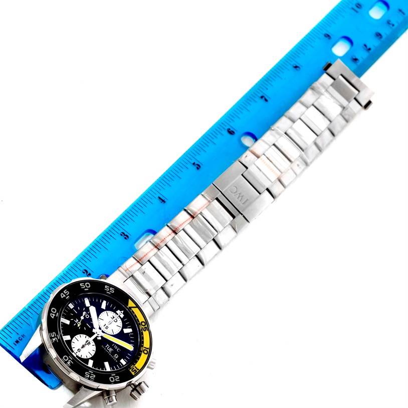 The image shows an IWC Aquatimer IW376701 Men's Stainless Steel Black Dial IW376701 Men's Stainless Steel Black Dial watch laid flat, with its face and metal bracelet aligned next to a blue ruler for measurement.
