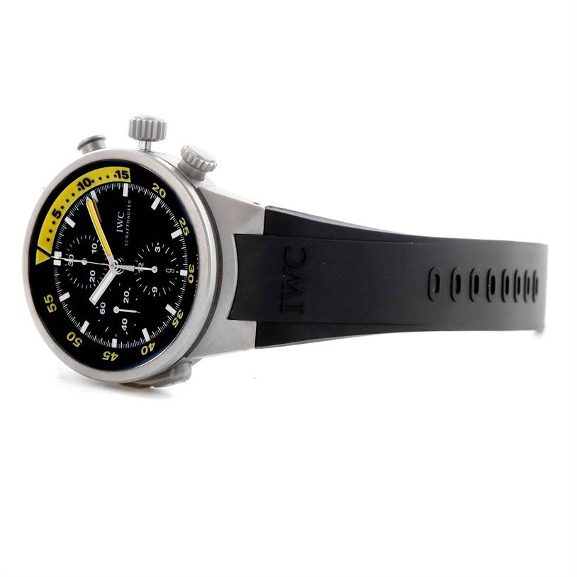 The IWC Aquatimer IW372304 Men's Titanium Black Dial IW372304 Men's Titanium Black Dial watch is shown at an angle displaying the watch face, bezel, crown, and part of the black rubber strap.