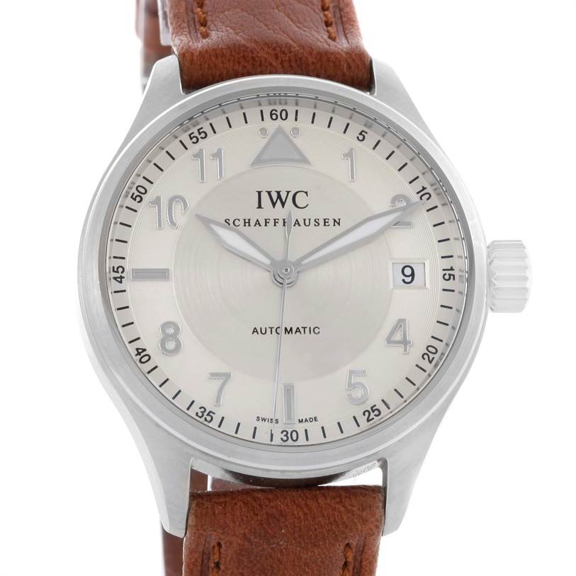 The image shows a front view of an IWC Pilot IW325602 Men's Stainless Steel Silver Dial IW325602 Men's Stainless Steel Silver Dial watch, displaying its face, crown, and part of the brown leather strap.