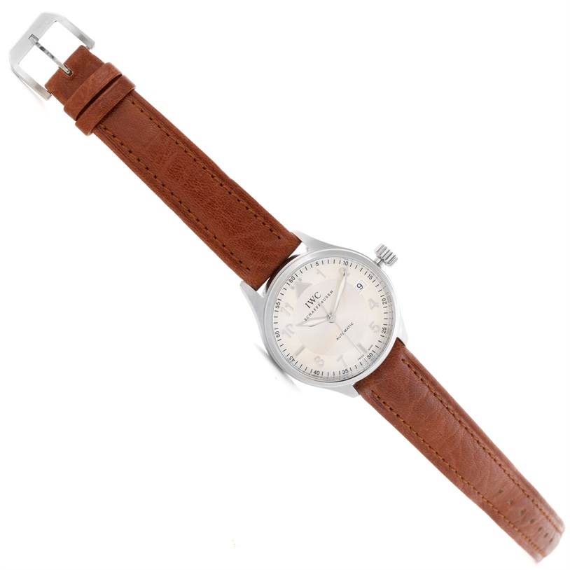 The IWC Pilot IW325602 Men's Stainless Steel Silver Dial IW325602 Men's Stainless Steel Silver Dial watch is shown from a top-down angle, displaying its face, bezel, crown, and brown leather strap.