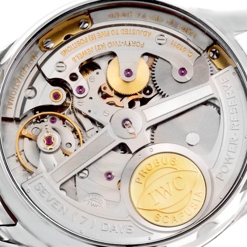 The image shows the back view of the IWC Portuguese IW500109 Men's Stainless Steel Black Dial IW500109 Men's Stainless Steel Black Dial watch, highlighting its intricate mechanical movement and parts.