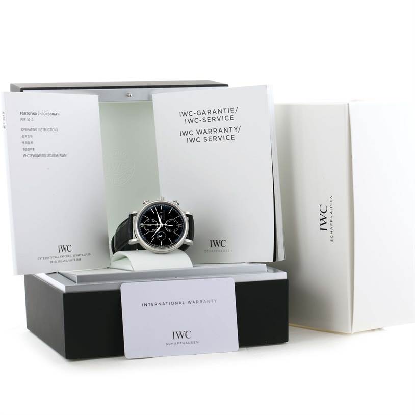The image shows a front view of an IWC Portofino IW371447 Men's Stainless Steel Black Dial IW371447 Men's Stainless Steel Black Dial model watch with its box, warranty card, and manuals.