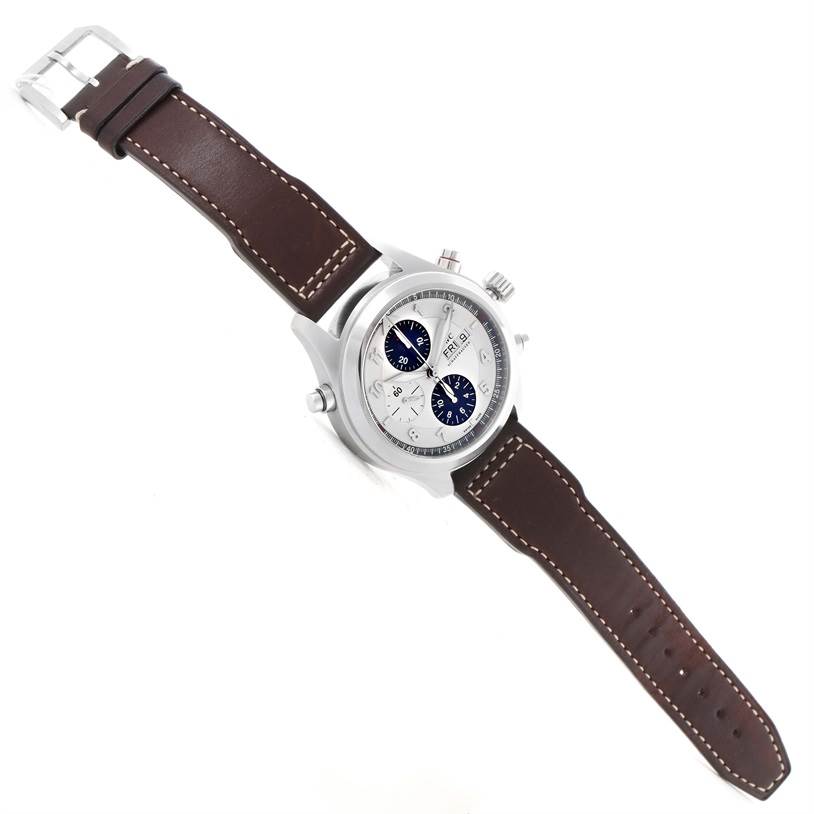 The IWC Pilot IW371806 Men's Stainless Steel Silver Dial IW371806 Men's Stainless Steel Silver Dial model watch is shown from a top-down angle, highlighting the face, crown, pushers, and brown leather strap with white stitching.