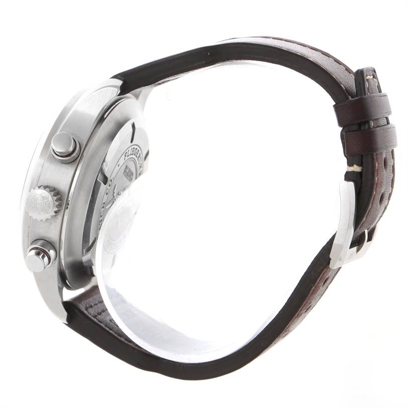 The image shows the side view of an IWC Pilot IW371806 Men's Stainless Steel Silver Dial IW371806 Men's Stainless Steel Silver Dial model watch, highlighting the crown, pushers, and leather strap.