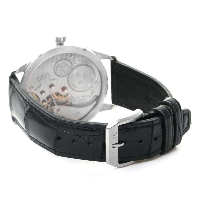 This image shows the back view of an IWC Portuguese IW544401 Men's Stainless Steel Silver Dial IW544401 Men's Stainless Steel Silver Dial watch, highlighting the exposed movement mechanism and the black leather strap with clasp.