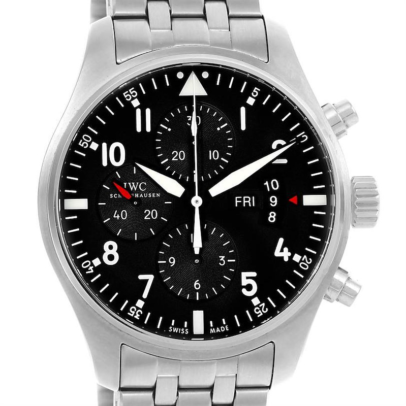 The image shows a front view of the IWC Pilot model watch, displaying its black dial, chronographs, and date function.