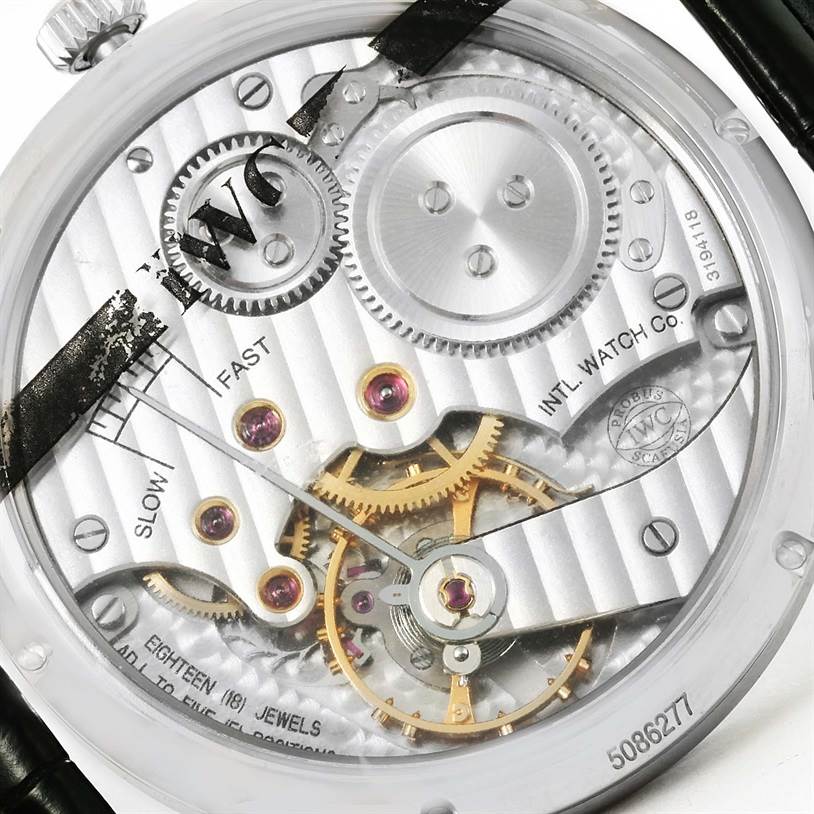 The image shows the back of an IWC Portuguese IW545405 Men's Stainless Steel Silver Dial IW545405 Men's Stainless Steel Silver Dial model watch, highlighting the intricate internal mechanics and gears.