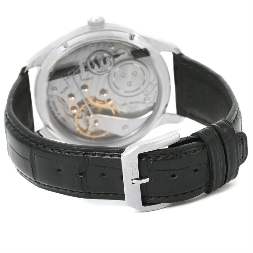 This image shows the back view of the IWC Portuguese IW545405 Men's Stainless Steel Silver Dial IW545405 Men's Stainless Steel Silver Dial model watch, highlighting its mechanical movement and black leather strap with a clasp.