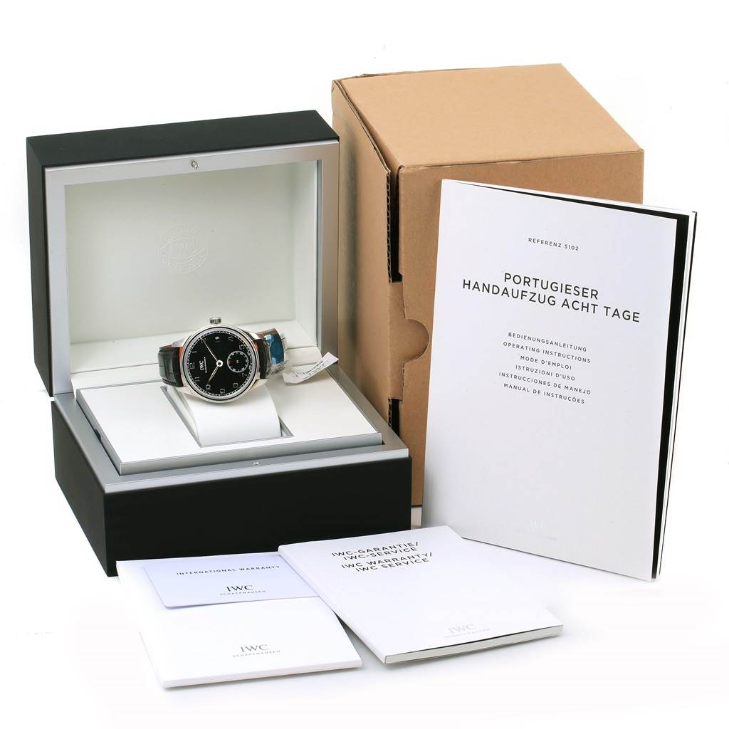 The image shows an IWC Portuguese IW510202 Men's Stainless Steel Black Dial IW510202 Men's Stainless Steel Black Dial model watch in its case with accompanying manuals and packaging.