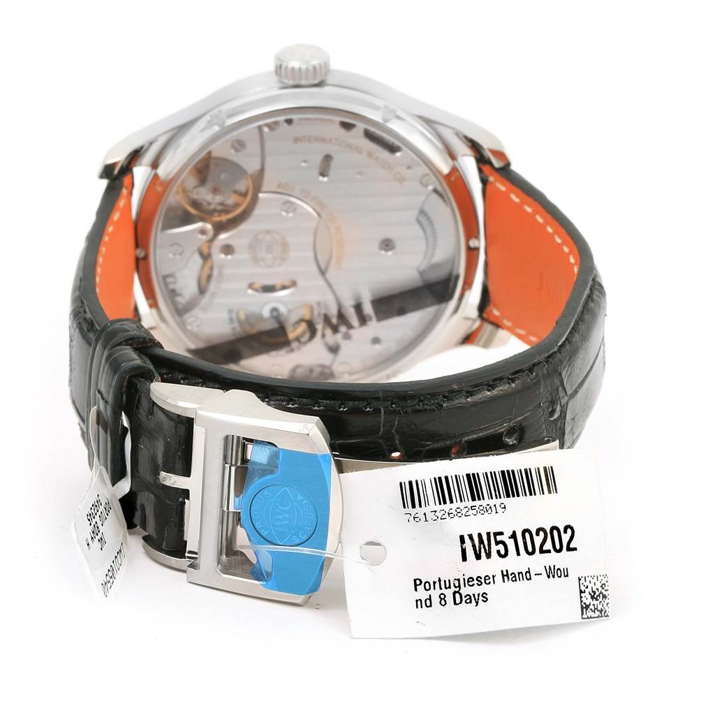 The image shows the back of the IWC Portuguese IW510202 Men's Stainless Steel Black Dial IW510202 Men's Stainless Steel Black Dial model watch, highlighting the movement and the leather strap with a clasp.