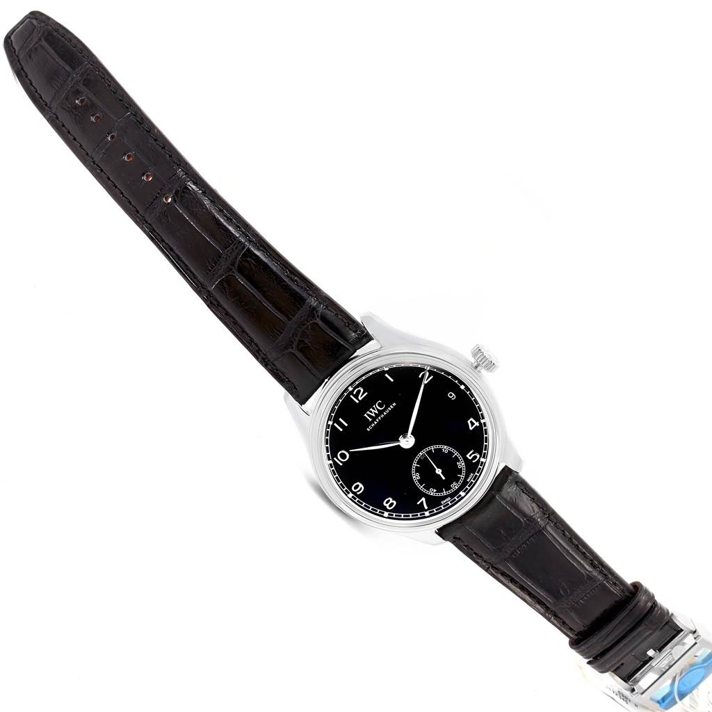 The image shows an IWC Portuguese IW510202 Men's Stainless Steel Black Dial IW510202 Men's Stainless Steel Black Dial model watch, including its face, crown, and leather strap, viewed from a top-down angle.