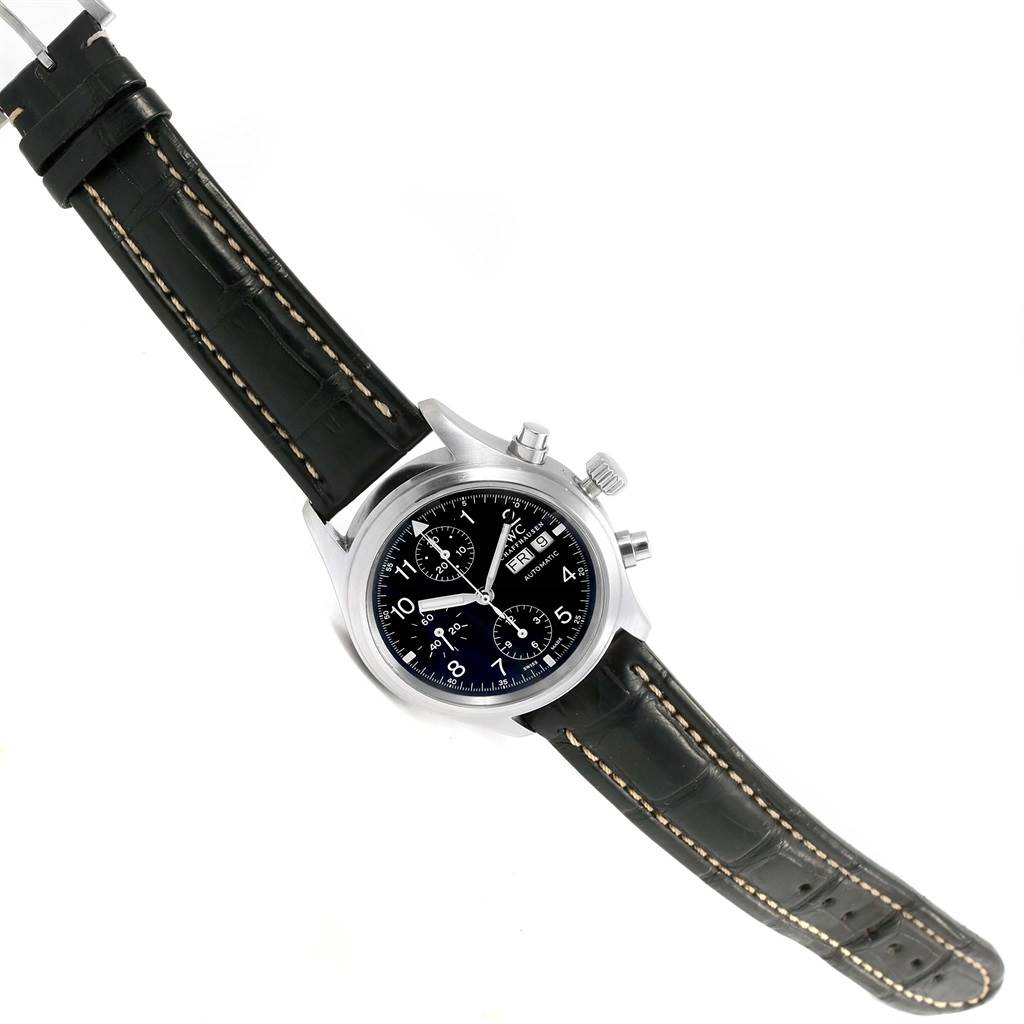 The image shows IWC Pilot IW370603 Men's Stainless Steel Black Dial IW370603 Men's Stainless Steel Black Dial model watch from an overhead angle, displaying the face, case, and leather strap.