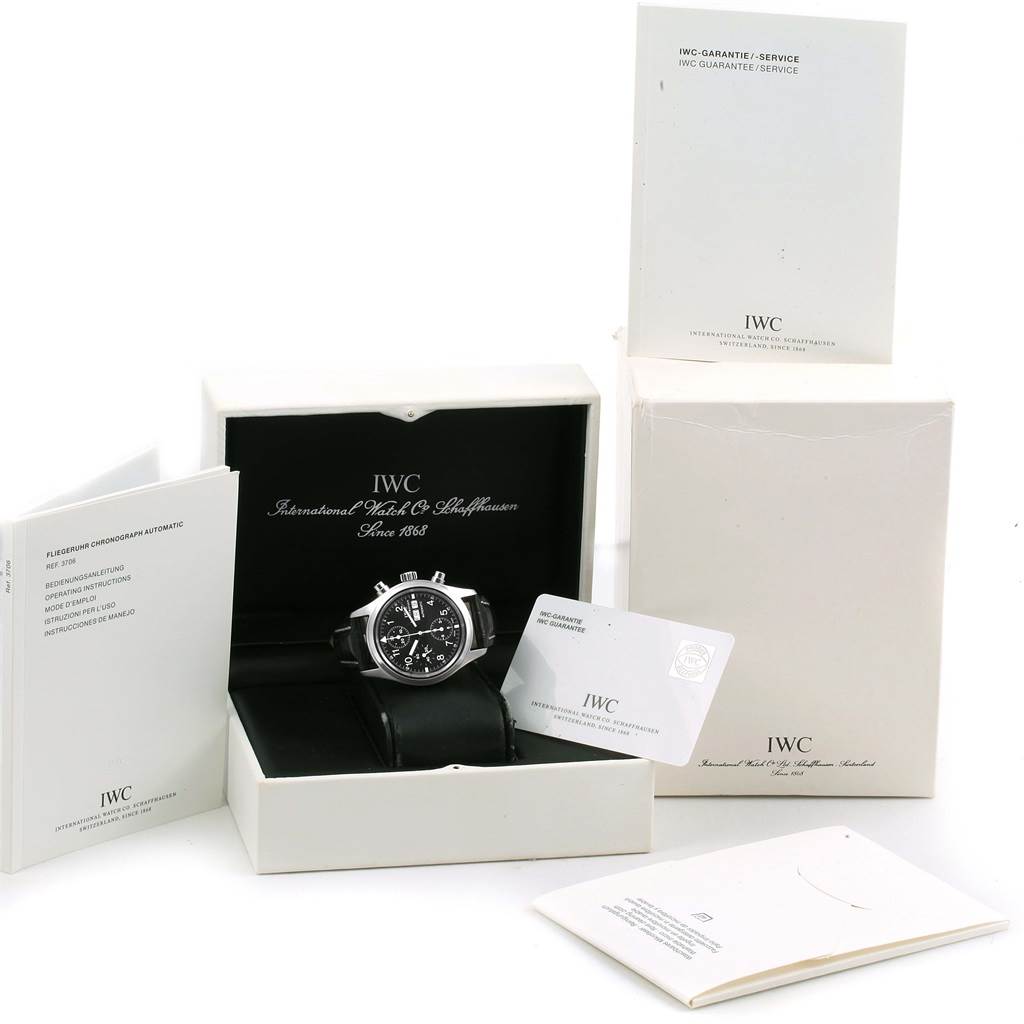 The IWC Pilot IW370603 Men's Stainless Steel Black Dial IW370603 Men's Stainless Steel Black Dial watch is shown front-facing in its box, accompanied by manuals and a guarantee card.
