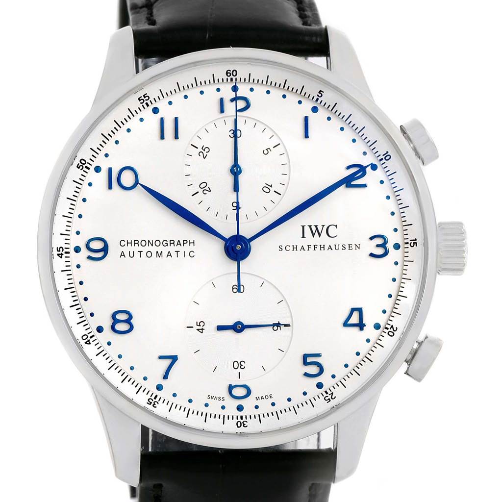 The image shows a front view of the IWC Portuguese IW371417 Men's Stainless Steel Silver Dial IW371417 Men's Stainless Steel Silver Dial Chronograph Automatic watch, highlighting its face, hands, and a portion of the leather strap.