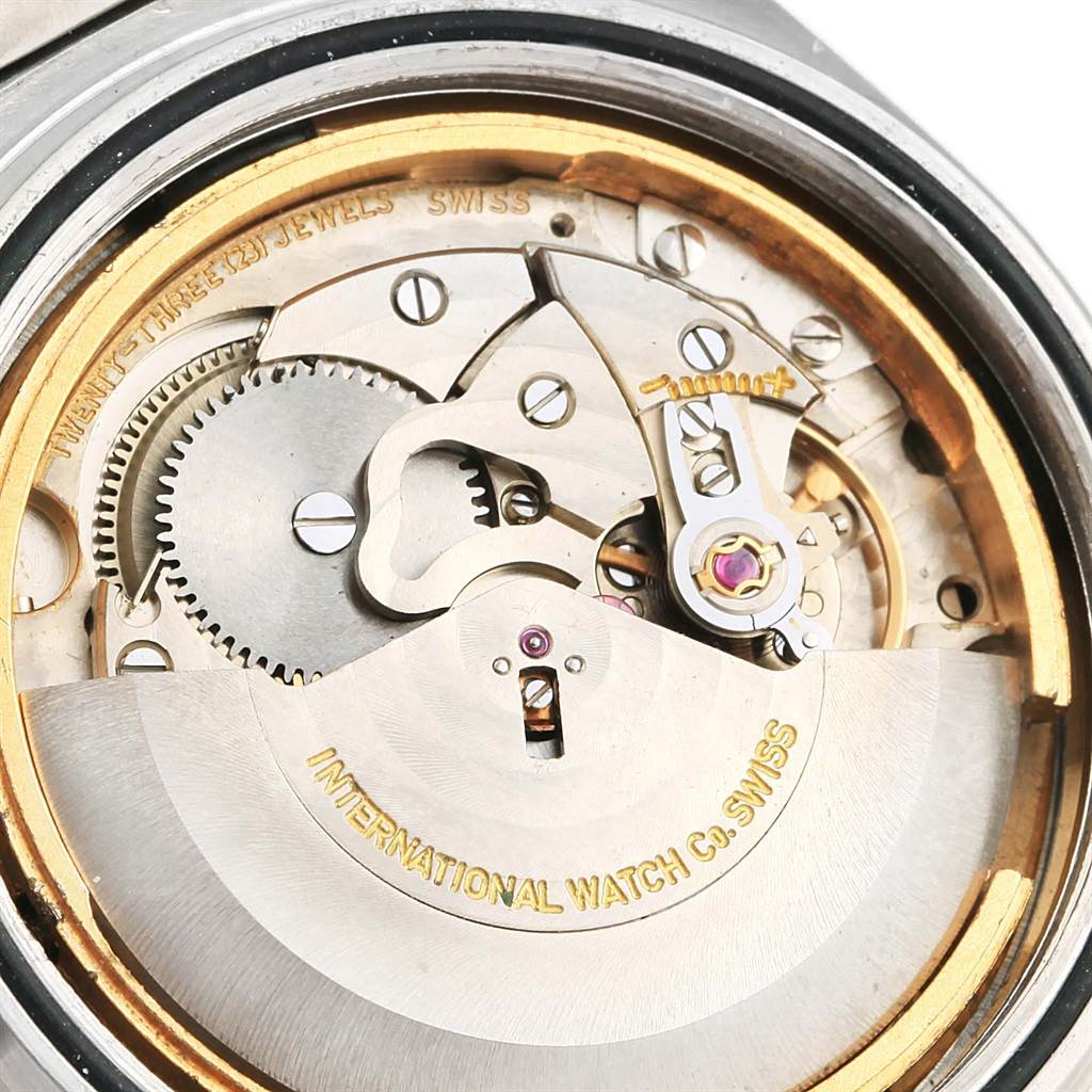 The image shows a close-up of the movement mechanism of an IWC Ingenieur 1832 Stainless Steel Silver Dial 1832 Stainless Steel Silver Dial watch, highlighting gears, screws, and the rotor.