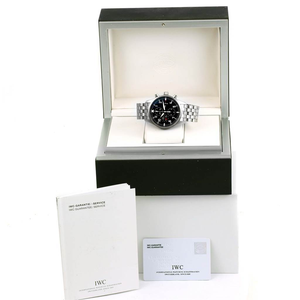 The image shows an IWC Pilot IW377704 Men's Stainless Steel Black Dial IW377704 Men's Stainless Steel Black Dial watch in its case, viewed from the front, along with the guarantee booklet and card.
