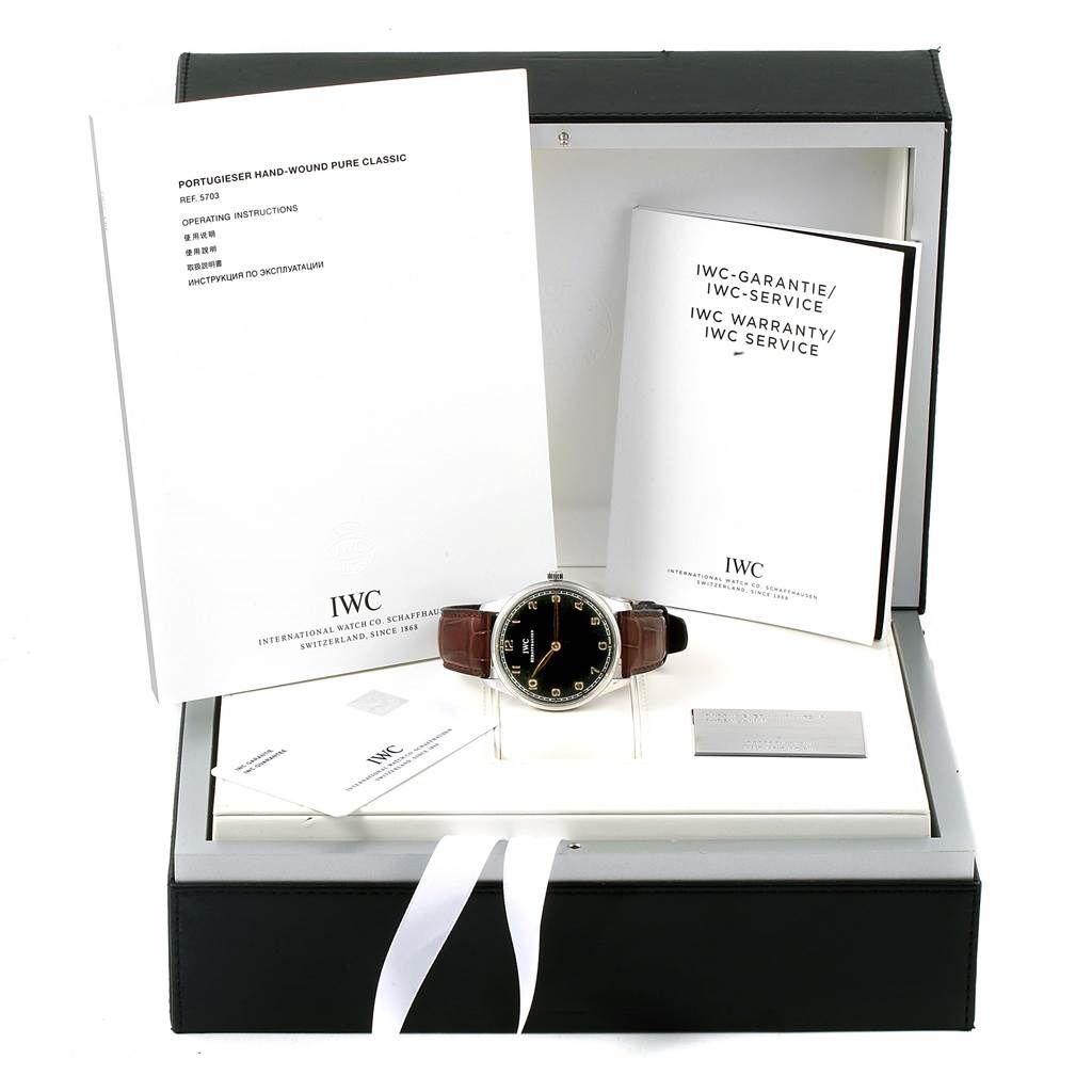 The image shows an IWC Ingenieur IW570302 Men's Stainless Steel Black Dial IW570302 Men's Stainless Steel Black Dial watch with a leather strap, positioned in an open presentation box with warranty and instruction booklets.