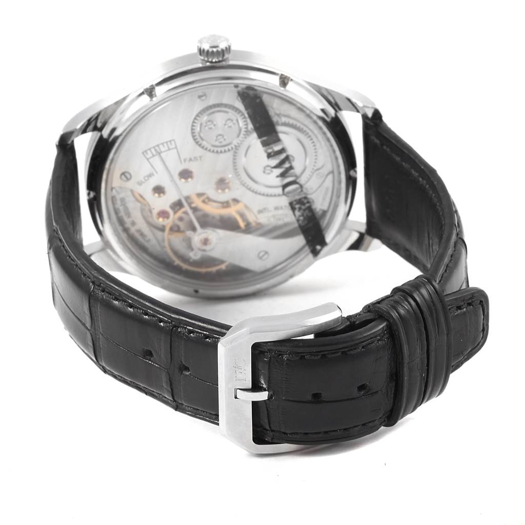 The image shows the back and side view of an IWC Portuguese IW545407 Men's Stainless Steel Black Dial IW545407 Men's Stainless Steel Black Dial watch, highlighting its transparent case back and black leather strap with buckle.