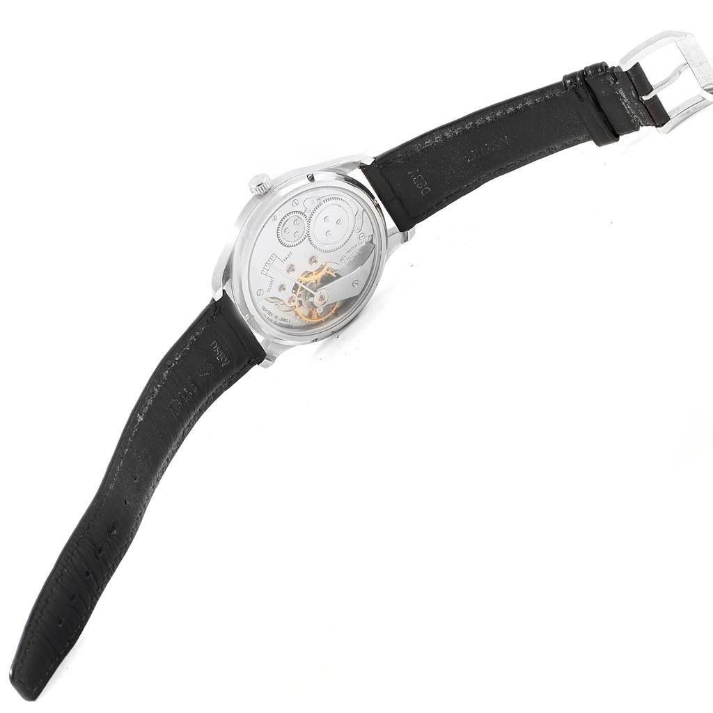 The image shows the back view of an IWC Portuguese IW545407 Men's Stainless Steel Black Dial IW545407 Men's Stainless Steel Black Dial watch, highlighting its internal mechanism and black leather strap.