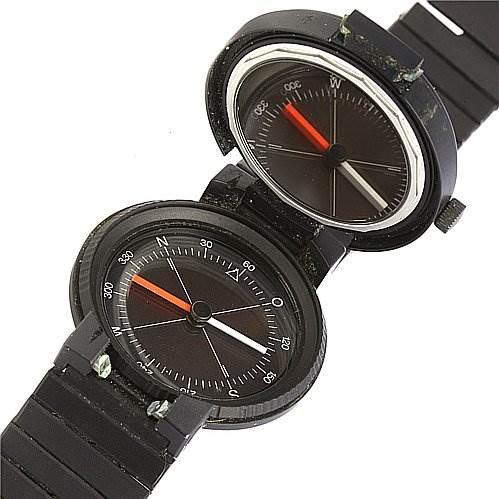 The image depicts a Vintage IWC watch shown from a top-down angle, displaying both the watch face and an integrated compass.