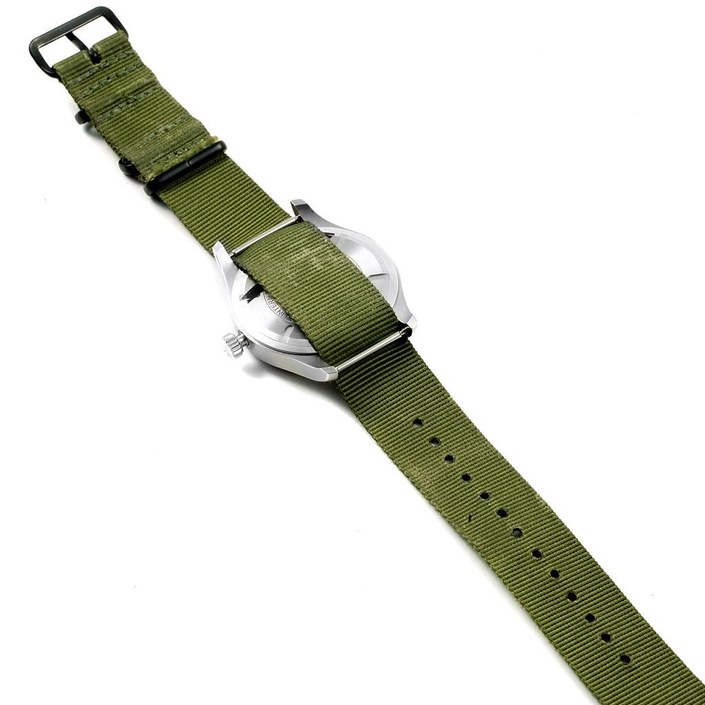 The image shows the back view of an IWC Pilot IW327011 Men's Stainless Steel Black Dial IW327011 Men's Stainless Steel Black Dial model watch with a green fabric strap.