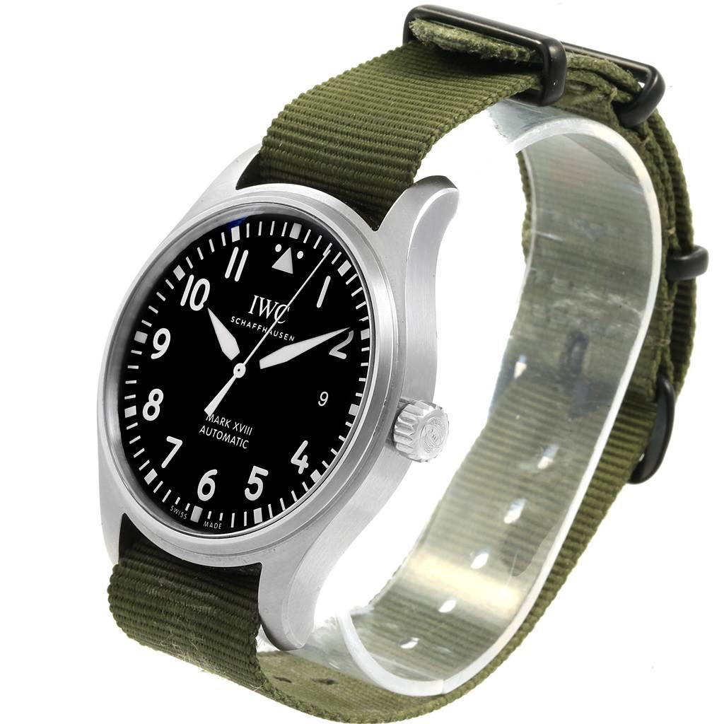 The IWC Pilot IW327011 Men's Stainless Steel Black Dial IW327011 Men's Stainless Steel Black Dial watch's front and side are shown, featuring its dial, case, crown, and green fabric strap.