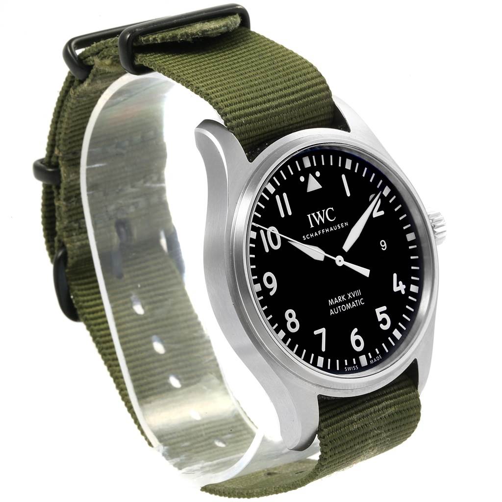 The image shows an IWC Pilot IW327011 Men's Stainless Steel Black Dial IW327011 Men's Stainless Steel Black Dial Mark XVIII watch at a slight angle, displaying the dial, case, and green fabric strap.