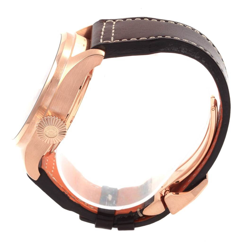 The IWC Pilot IW502701 Men's Rose Gold Blue Dial IW502701 Men's Rose Gold Blue Dial watch is shown from a side angle, highlighting its case, crown, and leather strap.