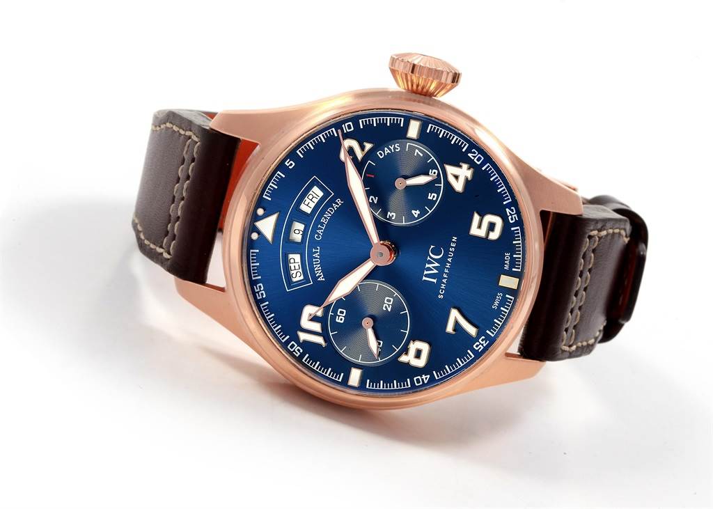 The IWC Pilot IW502701 Men's Rose Gold Blue Dial IW502701 Men's Rose Gold Blue Dial watch is shown at a slight angle, highlighting its blue dial, rose gold case, and leather strap.