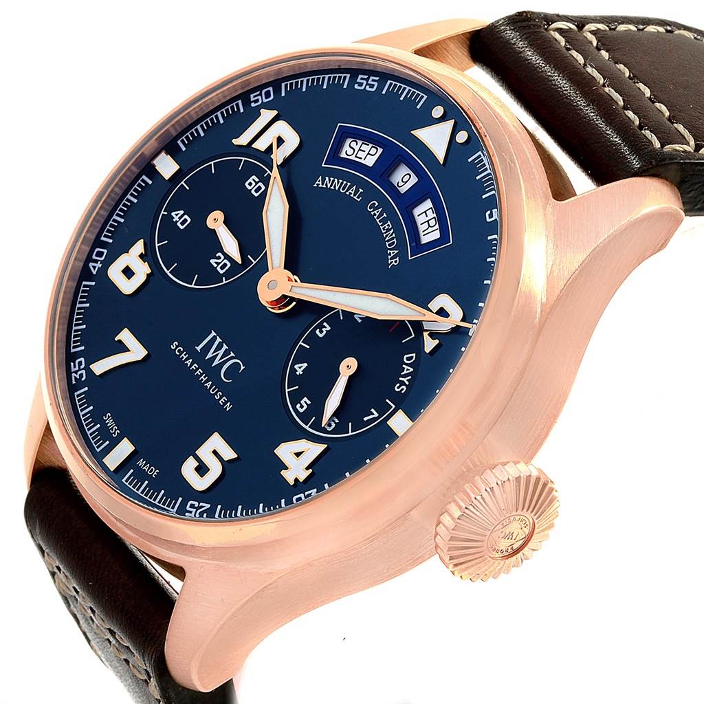 The IWC Pilot IW502701 Men's Rose Gold Blue Dial IW502701 Men's Rose Gold Blue Dial model is shown at a slight angle highlighting the blue dial, annual calendar, crown, and part of the leather strap.