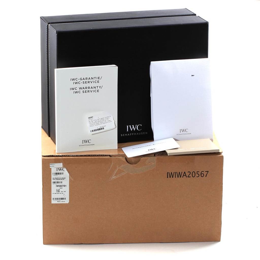 The image shows packaging parts and accessories for an IWC Pilot IW502701 Men's Rose Gold Blue Dial IW502701 Men's Rose Gold Blue Dial model watch, including warranty, service booklets, and boxes.