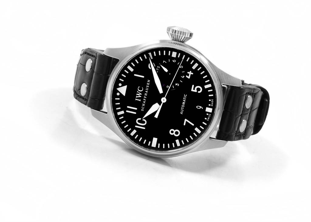 The IWC Pilot IW500901 Men's Stainless Steel Black Dial IW500901 Men's Stainless Steel Black Dial model watch is shown from an angled top view, displaying the black dial, numerals, and leather strap with rivets.