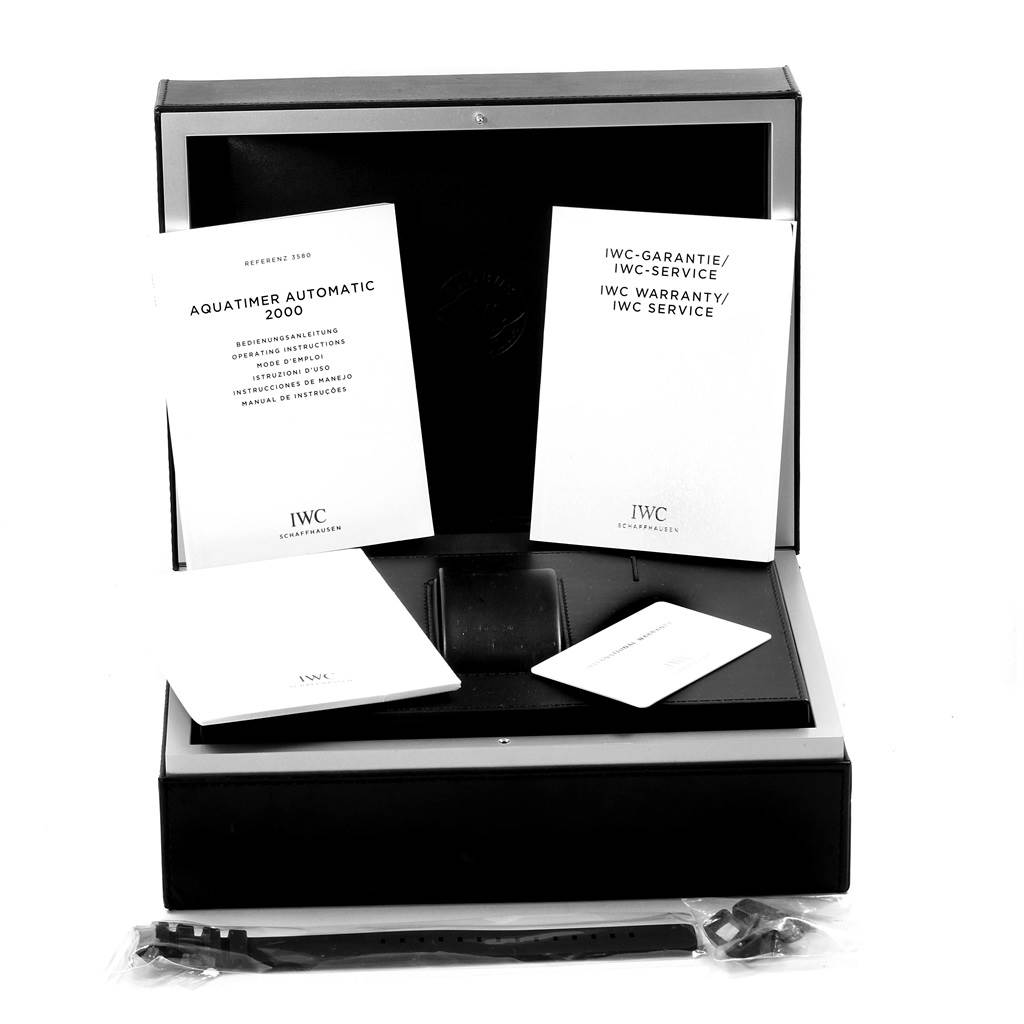 The image shows the IWC Aquatimer IW358002 Men's Stainless Steel Black Dial IW358002 Men's Stainless Steel Black Dial watch accessories, including manuals, warranty card, and an additional strap, in an open box.