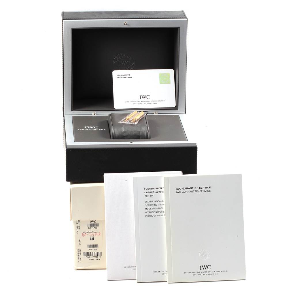 The image shows the accessories and packaging for the IWC Pilot IW371705 Men's Stainless Steel Silver Dial IW371705 Men's Stainless Steel Silver Dial model watch, including the box, warranty card, and manuals.