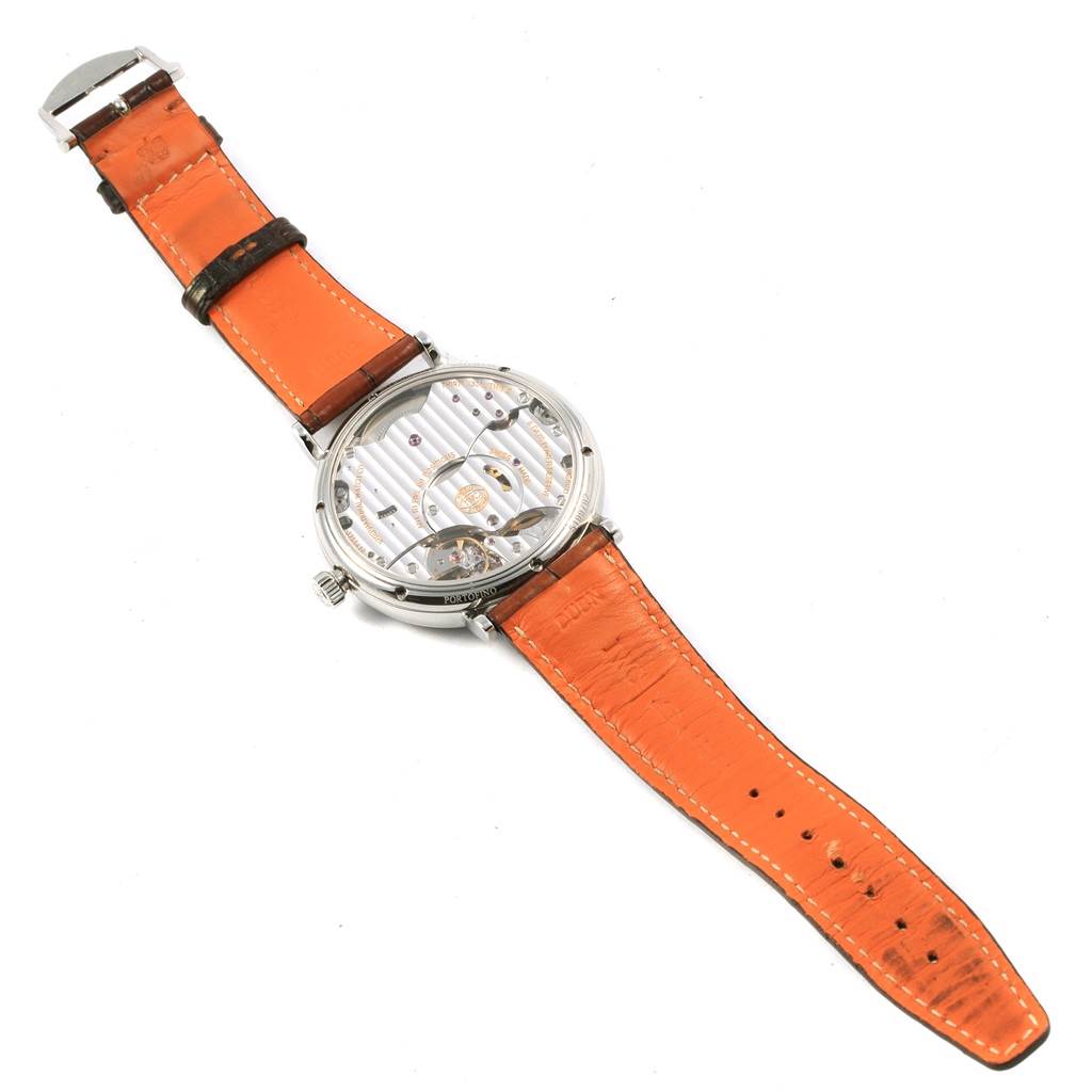 The image shows the back view of the IWC Portofino IW510106 Men
s Stainless Steel Blue Dial IW510106 Men
s Stainless Steel Blue Dial watch, highlighting its orange leather strap and exhibition case back.