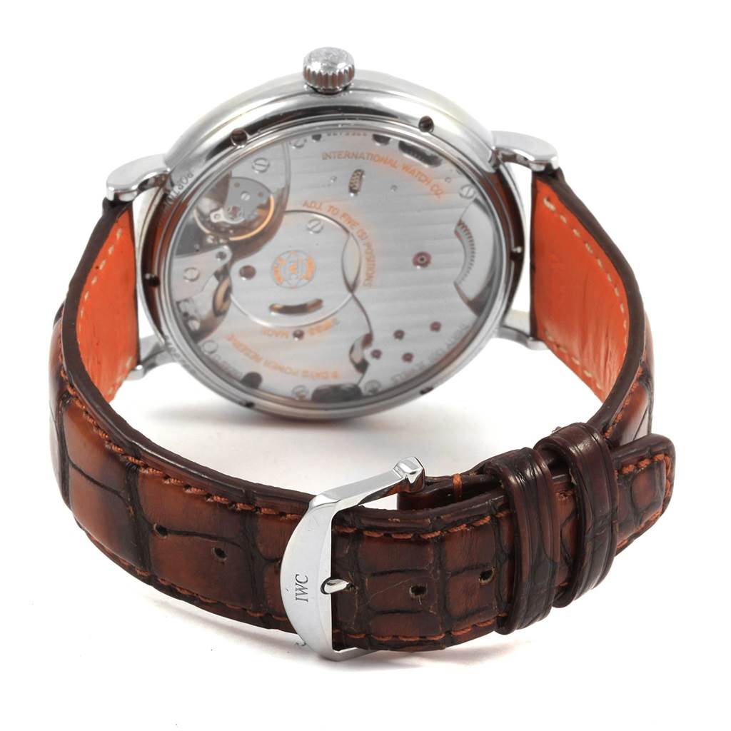 The image shows the back and strap of the IWC Portofino IW510106 Men
s Stainless Steel Blue Dial IW510106 Men
s Stainless Steel Blue Dial watch at an angled view, highlighting the mechanical movement and leather strap.