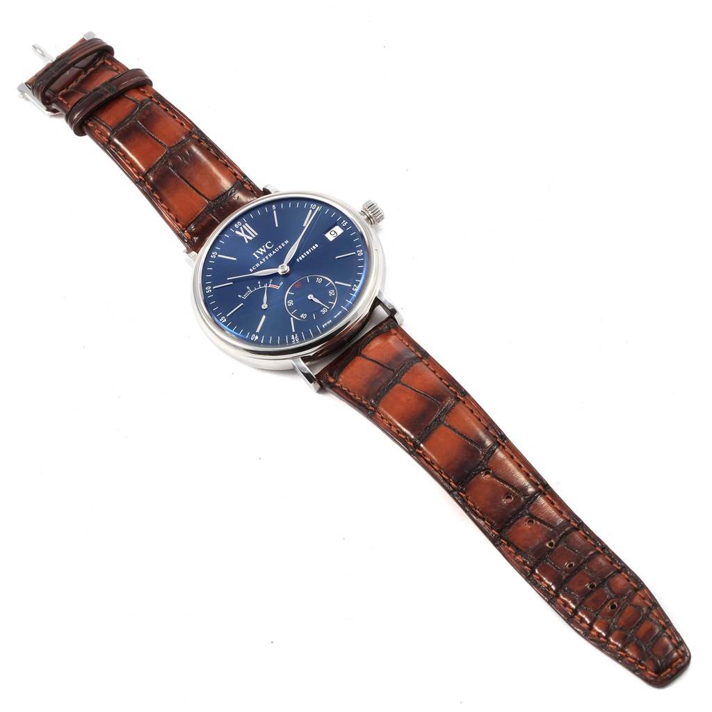 The IWC Portofino IW510106 Men
s Stainless Steel Blue Dial IW510106 Men
s Stainless Steel Blue Dial watch is shown from an overhead angle, displaying its blue dial and brown leather strap.