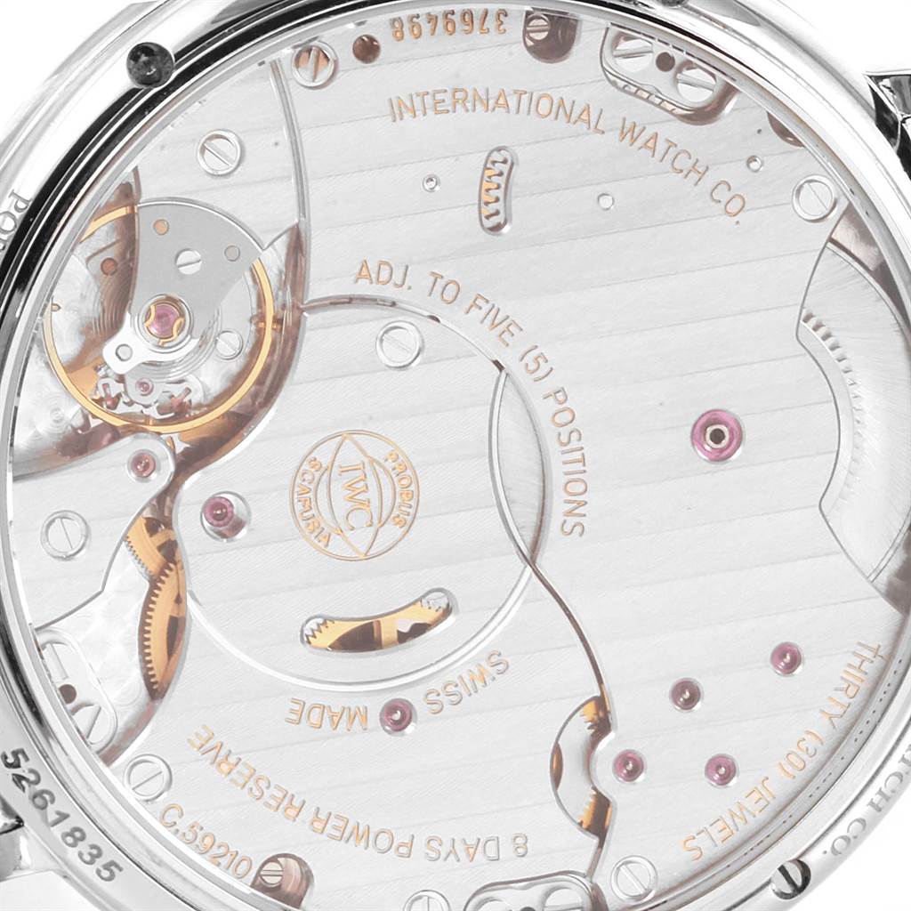 The image shows the back of a Portofino model by IWC, focusing on the movement and inner workings.