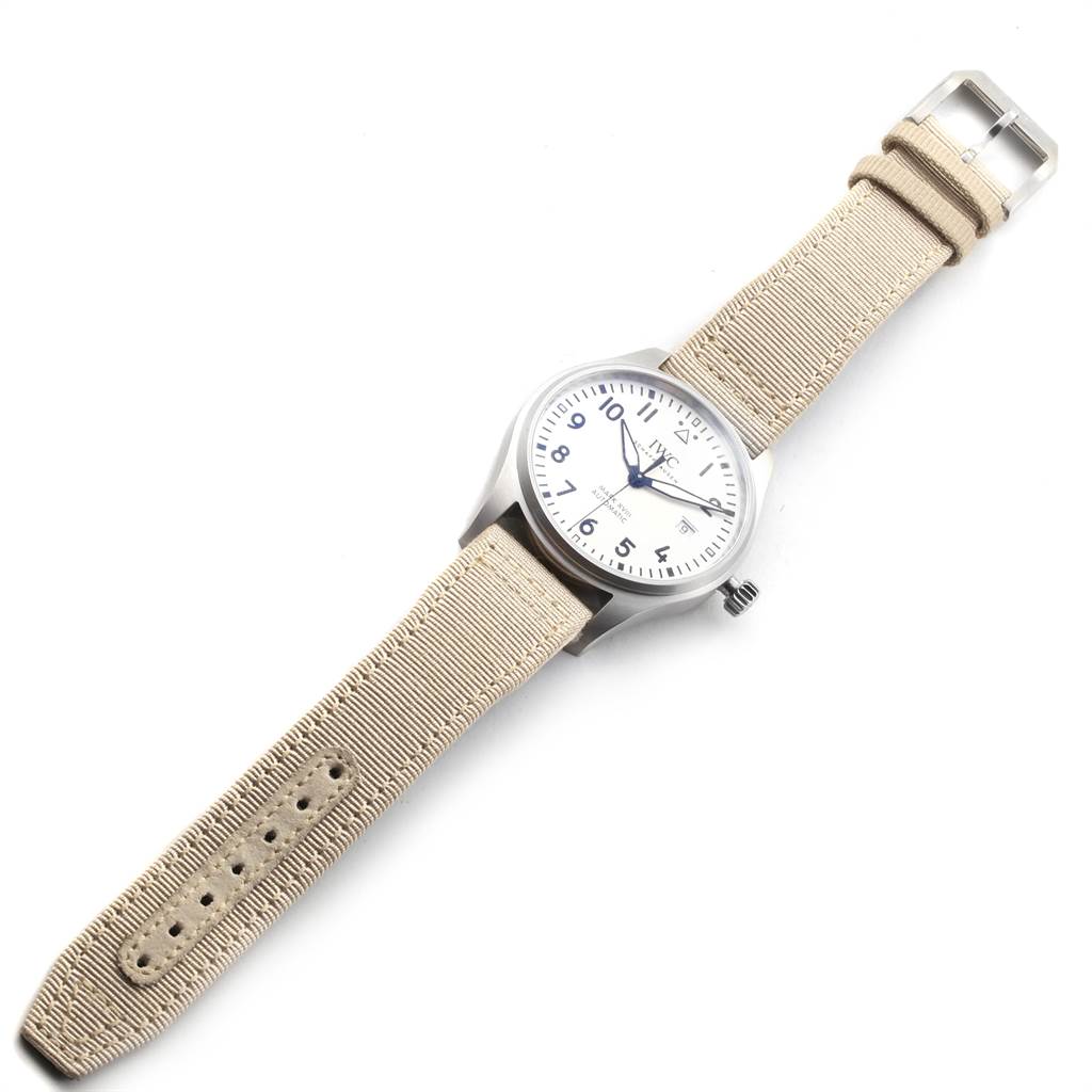 The IWC Pilot IW327017 Men's Stainless Steel Silver Dial IW327017 Men's Stainless Steel Silver Dial model watch is shown at an angled top view, displaying its face, beige strap, and buckle.