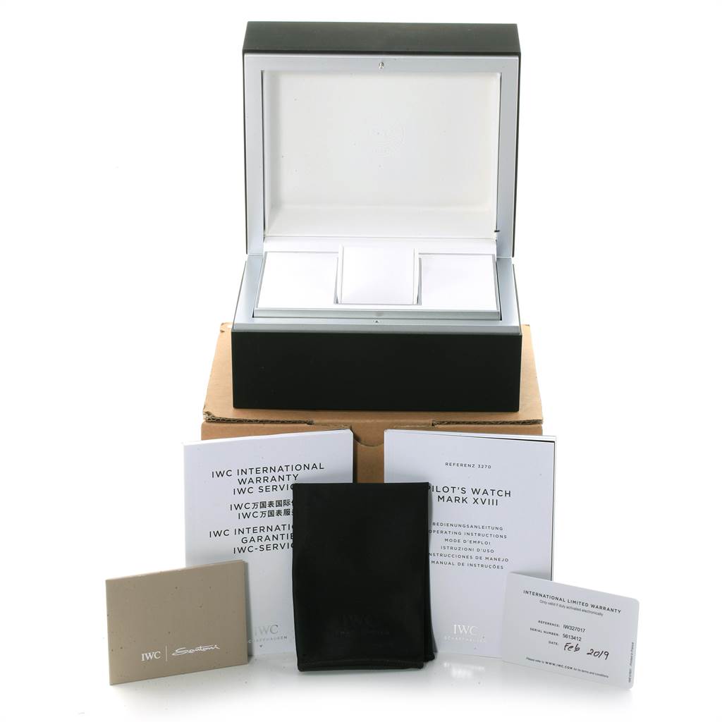 The image shows an IWC Pilot IW327017 Men's Stainless Steel Silver Dial IW327017 Men's Stainless Steel Silver Dial model watch packaging, including the watch box, manuals, warranty cards, and a cloth.