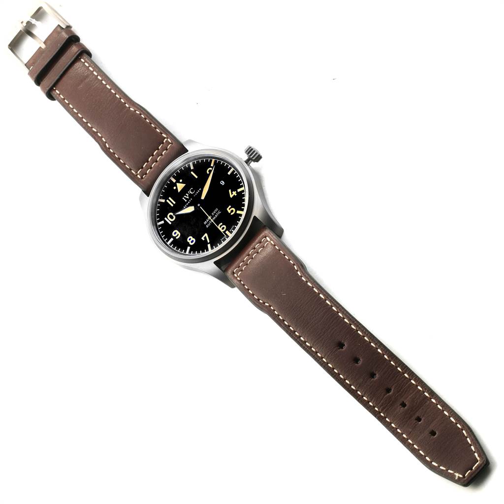 This image shows a top view of the IWC Pilot IW327006 Men's Titanium Black Dial IW327006 Men's Titanium Black Dial model watch featuring its dial, bezel, crown, and brown leather strap.
