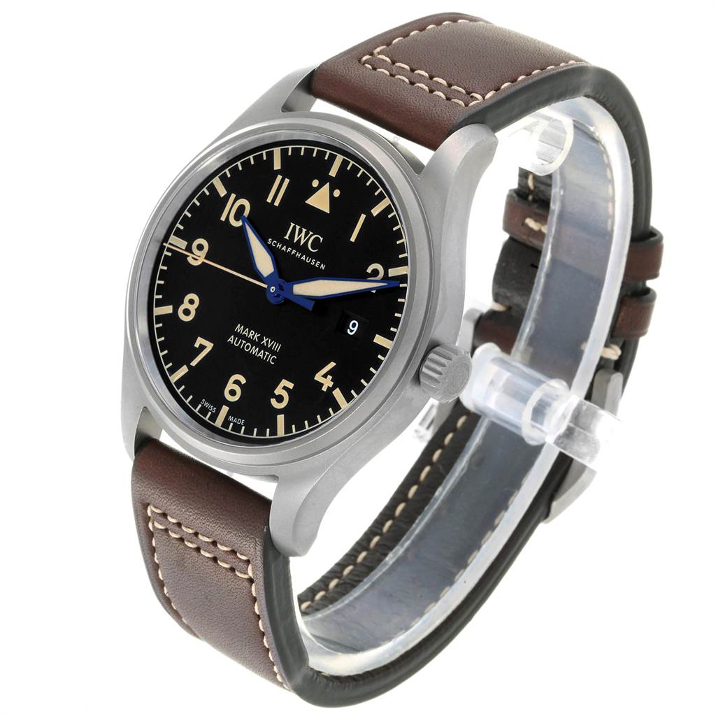 The image shows an angled view of an IWC Pilot IW327006 Men's Titanium Black Dial IW327006 Men's Titanium Black Dial Mark XVIII watch, highlighting its black dial, brown leather strap, and stainless steel case.