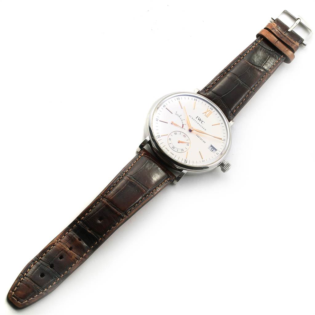 This image shows an overhead view of an IWC Portofino IW510103 Men's Stainless Steel Silver Dial IW510103 Men's Stainless Steel Silver Dial watch with a white dial and brown leather strap.
