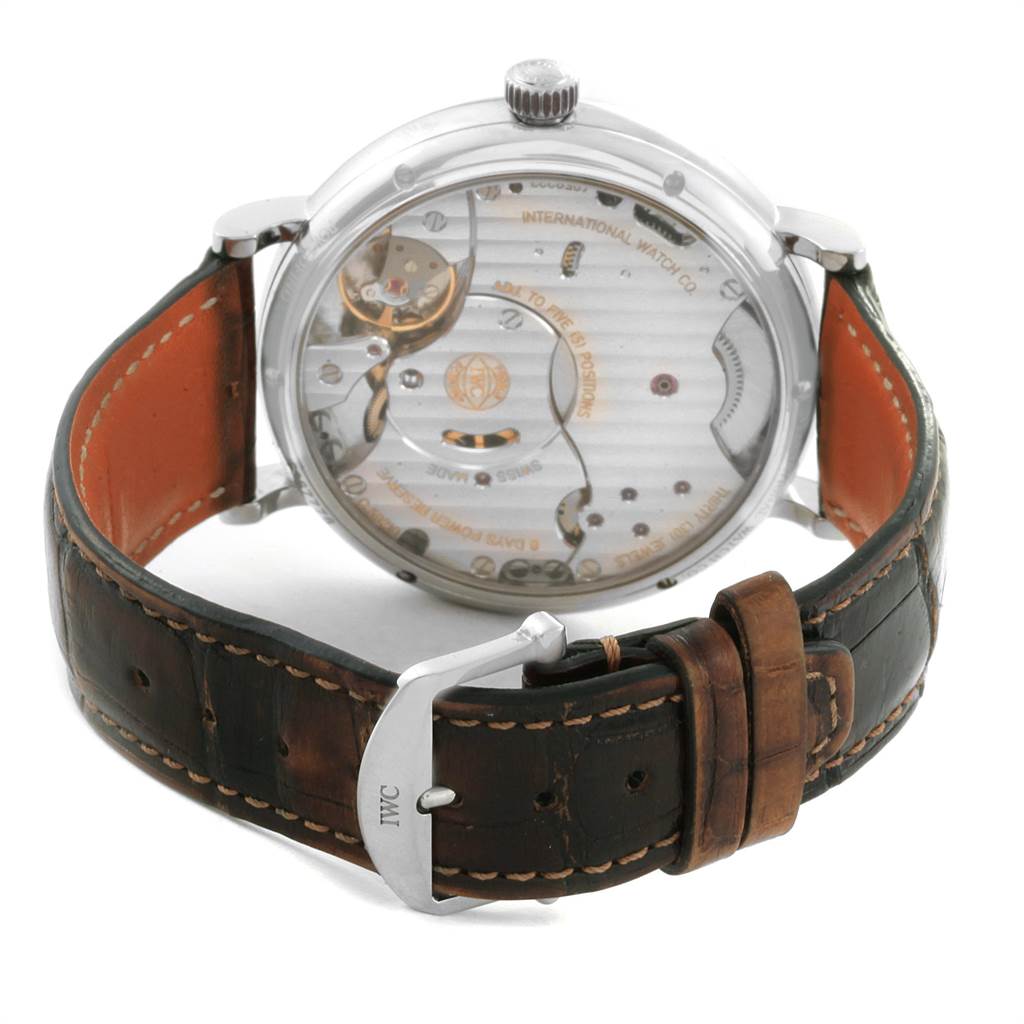 The image shows the back view of an IWC Portofino IW510103 Men's Stainless Steel Silver Dial IW510103 Men's Stainless Steel Silver Dial watch, displaying the movement and leather strap with the IWC logo on the buckle.