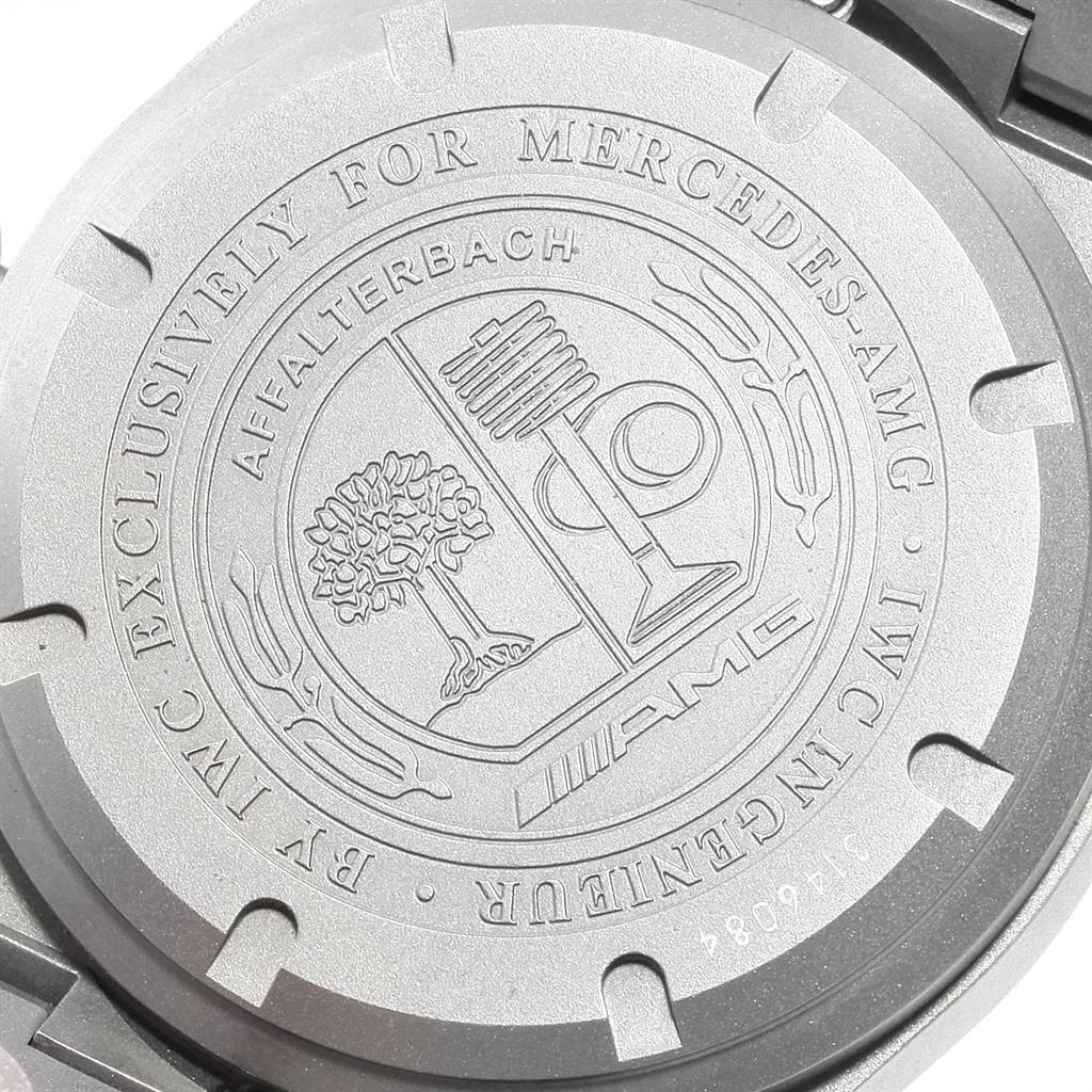 The image shows the back casing of an IWC Ingenieur IW322702 Men's Titanium Black Dial IW322702 Men's Titanium Black Dial watch with engraving related to Mercedes-AMG.