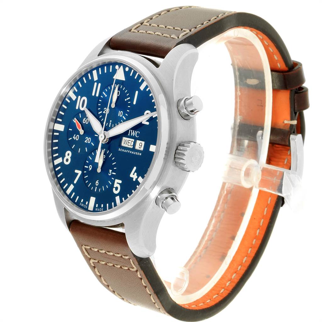 The image shows an IWC Pilot IW377714 Men's Stainless Steel Blue Dial IW377714 Men's Stainless Steel Blue Dial model watch at a three-quarter angle, highlighting its blue dial, brown leather strap, and side pushers.